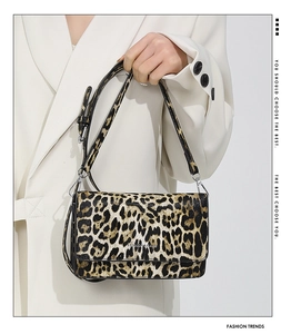 Detail of trendy leopard print shoulder bag with silver Fashion Bags logo and leather strap