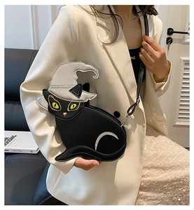 Detail of black cat shaped PU leather crossbody bag featuring a sparkling witch hat accent