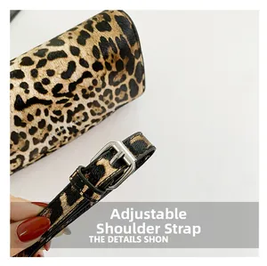 Detail of adjustable shoulder strap with silver buckle on leopard print shoulder bag
