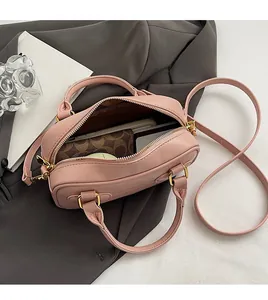 Interior view of pink crocodile pattern handbag showing large storage space and luxury metal zipper