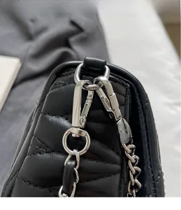 Close-up of quilted black leather texture and premium silver hardware hook details
