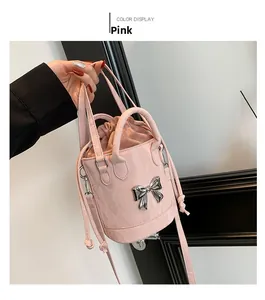 Detailed view of a pink bucket bag featuring a silver bow buckle and drawstring design