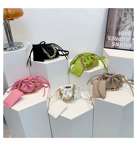 Group display of stylish pleated bucket bags with chunky gold chains and matching card holders
