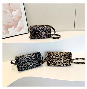 Detailed view of three vintage leopard print mini flap bags with adjustable leather straps