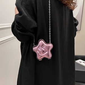 Pink star-shaped crossbody bag with embossed smiley face and silver metal chain strap