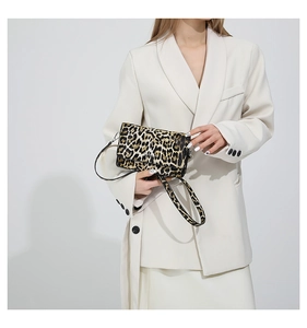 Detail shot of vintage leopard print flap bag with textured finish and slim shoulder strap