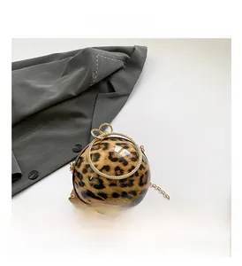 Detail of leopard print spherical evening bag with rhinestone-embellished gold handle