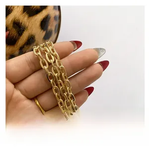 Detail of elegant gold metal chain strap on a leopard print evening bag accessory