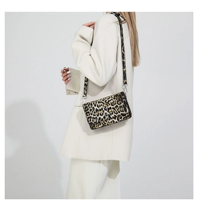 Detailed close-up of retro leopard print flap bag with slim adjustable shoulder strap