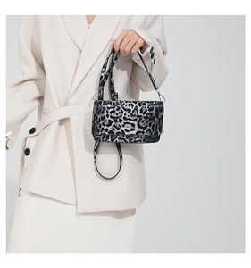 Detail of silver-black leopard print baguette bag with adjustable shoulder strap