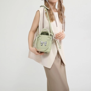 French chic light green bucket bag with silver mirror bow and adjustable shoulder strap