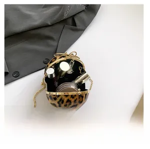 Close-up of leopard print sphere bag interior showing capacity for makeup and accessories