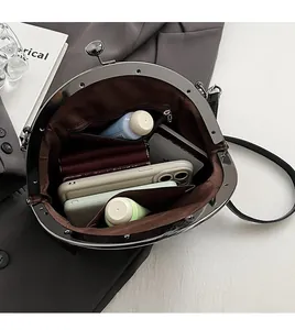 Detail view of the black retro shell bag's spacious interior with a zipper pocket