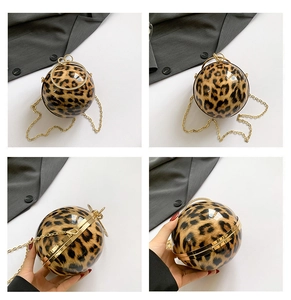 Detail of spherical leopard print bag with gold metal ring handle and chain strap