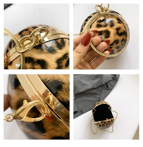 Detail view of leopard print spherical clutch with sparkling rhinestone handle and chain