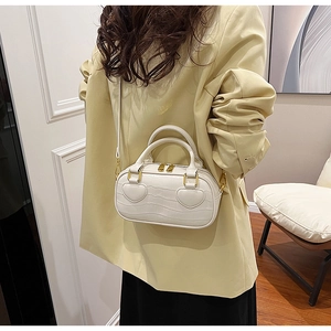 White faux crocodile leather handbag featuring two heart appliqués and gold hardware accents