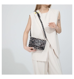 Detail of trendy leopard print rectangular flap bag with a matching slim shoulder strap