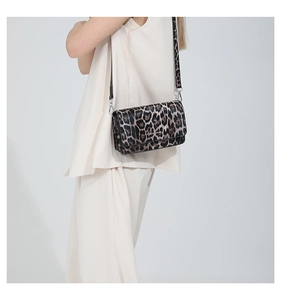 Detail of leopard print crossbody bag with texture and silver metal D-ring attachment