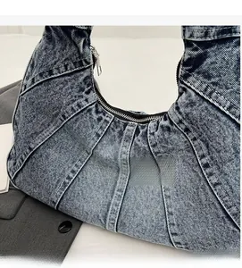 Close-up of blue washed denim fabric texture with durable double stitching and zipper