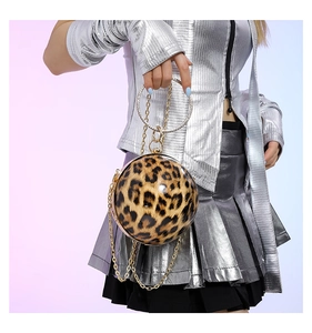 Detail of leopard print spherical handbag with rhinestone handle and gold chain strap