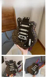 Détail du sac bandoulière en forme de guitare avec motif damier marron et rivets