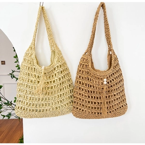 Detail of woven straw tote bags with hollow mesh pattern and pearl tassel charms