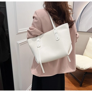 White pleated tote bag with large capacity shown in a stylish shoulder carrying view