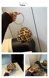 Detail view of yellow leopard print spherical clutch with rhinestone ring and gold chain