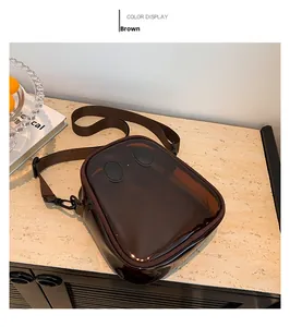 Detailed view of the brown semi-transparent jelly bag with cartoon eye patches and nylon strap