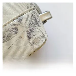 Macro detail of twill fabric with butterfly print and premium silver metal zipper