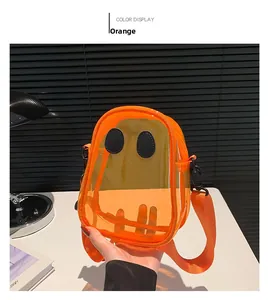 Detail of ghost-shaped orange PVC crossbody bag with black eye patches and fabric strap