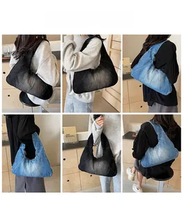 Detail view of denim patchwork hobo bags in blue and black shown on a model