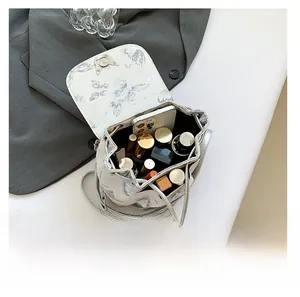 Detail showing the spacious interior of white bucket bag with butterfly print