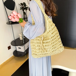 Hollow straw tote bag with pearl tassel detail and large capacity for summer beach use