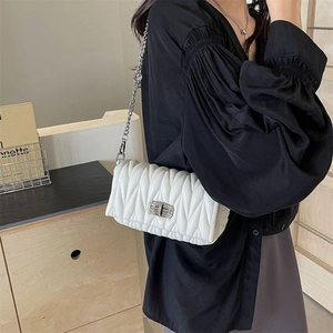 White matelassé quilted crossbody bag with silver chain strap and metal turn-lock