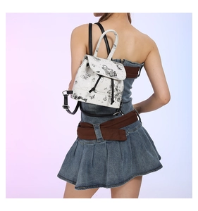 Detail of white mini backpack with black butterfly and star constellation patterns