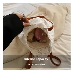 Internal view of white lace tote bag showing large capacity and magnetic closure