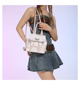 Detail of pink PU leather backpack with butterfly prints and metal buckle on model