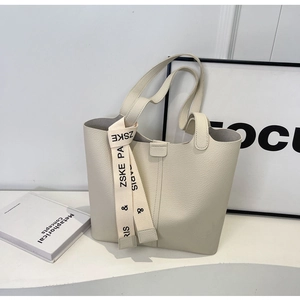 Minimalist beige pebble leather tote bag featuring a decorative printed ribbon detail