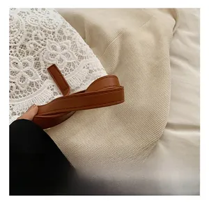 Close-up of white floral crochet lace texture and brown leather handle with stitching