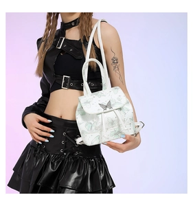 Mini white backpack with butterfly pattern and 3D metal buckle shown on a model