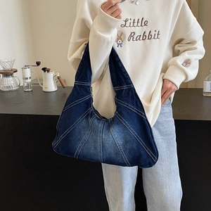 Fashionable dark blue denim crescent shoulder bag with white contrast stitching details