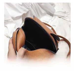 Top view of mini brown crossbody bag showing spacious interior and cute cat ear design