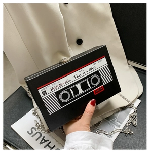 Detail of creative vintage cassette clutch with silver chain and magnetic metal lock