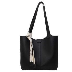 Large black pebbled leather tote bag with stylish decorative ribbon and long shoulder straps
