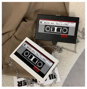 Detail shot of vintage radio cassette tape bags with silver chain straps in black and white