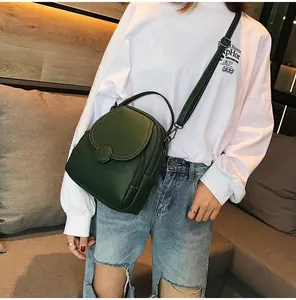 Close-up of dark green pebble leather backpack with flip cover and side zipper detail