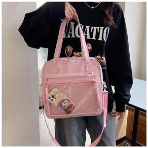Detailed close-up of a pink Ita bag featuring a clear window for cute doll display