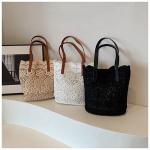 Detailed close-up of handmade floral lace bucket bags in apricot, white, and black colors