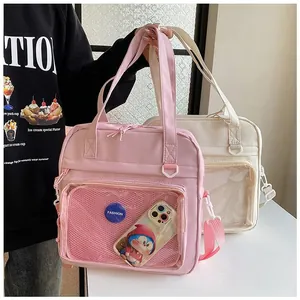 Detail of pink and beige ita bags with transparent mesh pockets and fashion text